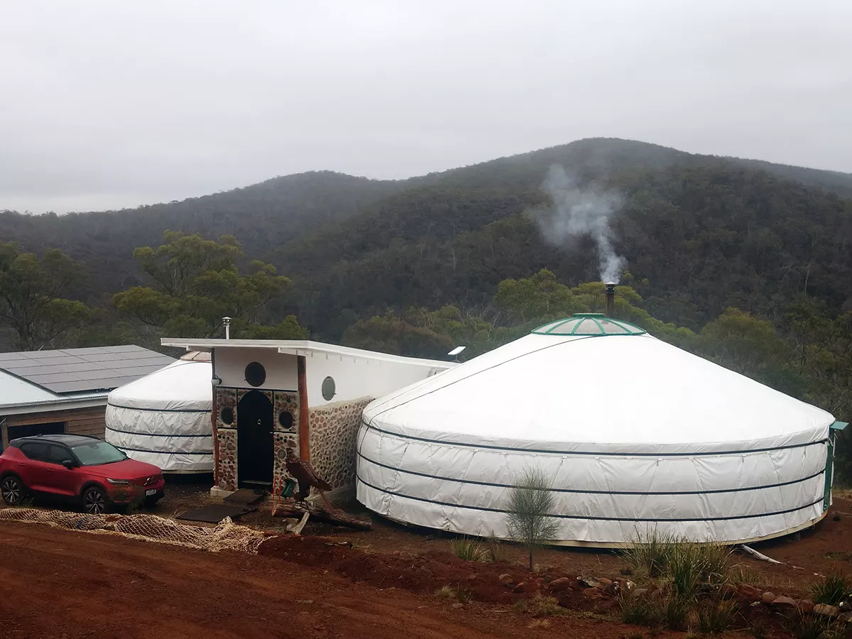smoke coming out of a yurt, stove placed at the center