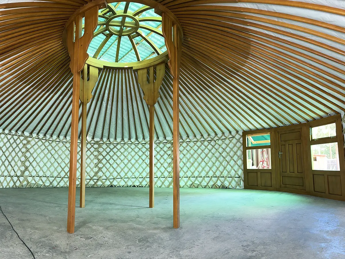 a huge Mongolian yurt with 4 pillars and teak interior