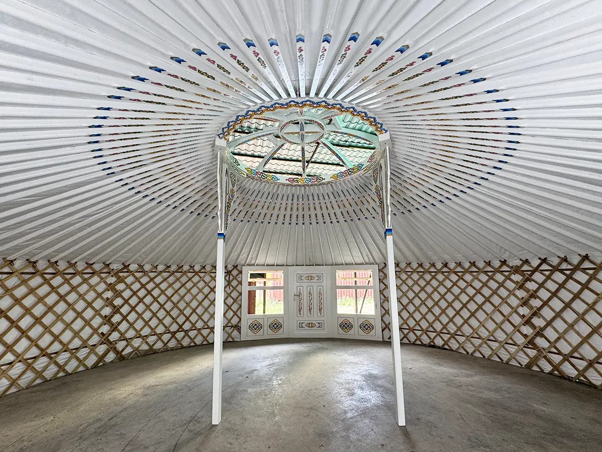 White interior of a Mongolian yurt with Mongolian traditional motif decoration