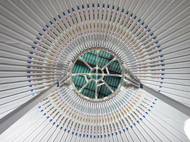Mongolian yurt with white interior with traditional motif decoration