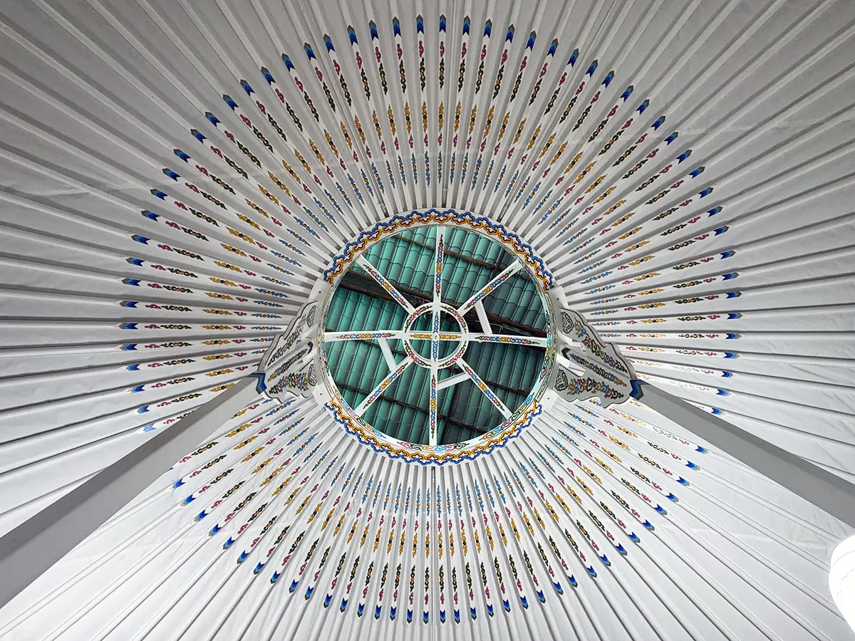 Mongolian yurt with white interior with traditional motif decoration