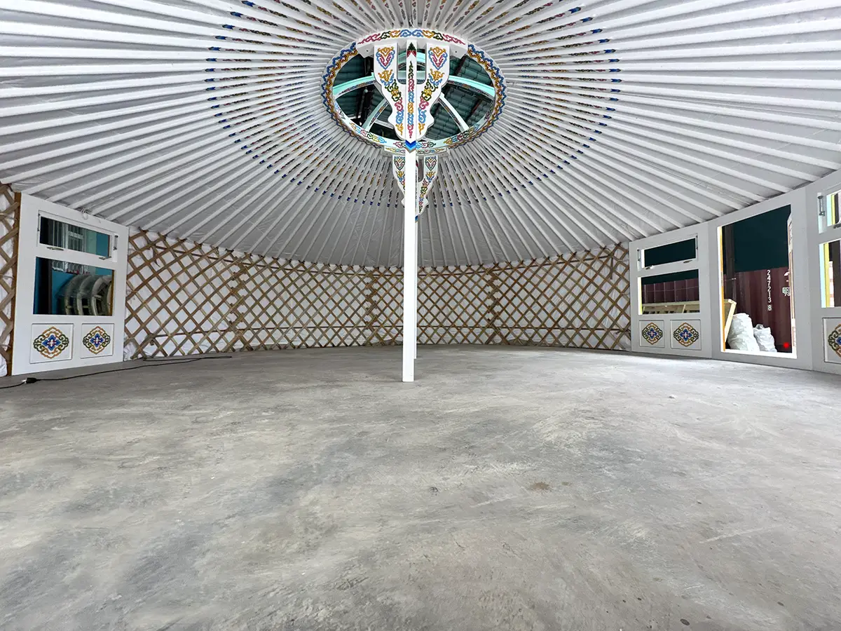 White interior of a Mongolian yurt with a Mongolian traditional motif decoration