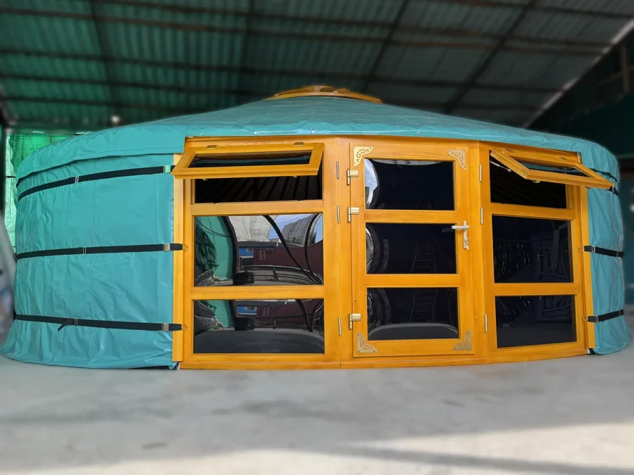 A Mongolian yurt with two front windows, windows and door are all made of glass, in green cover.