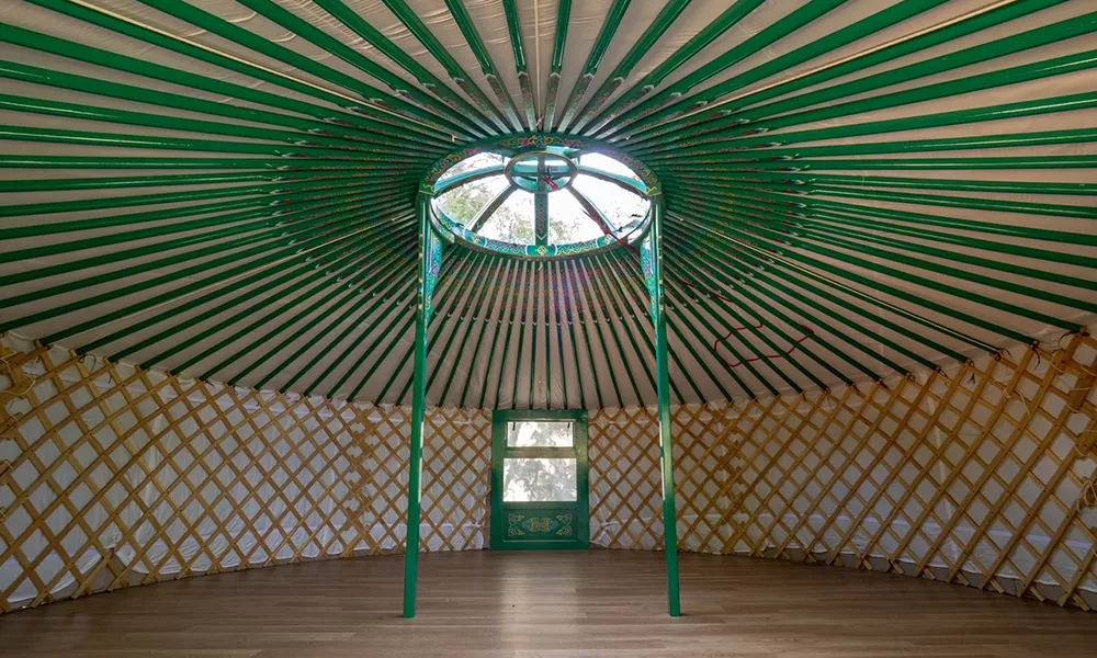 Inside of 6.7m (22ft) yurt with green painting.