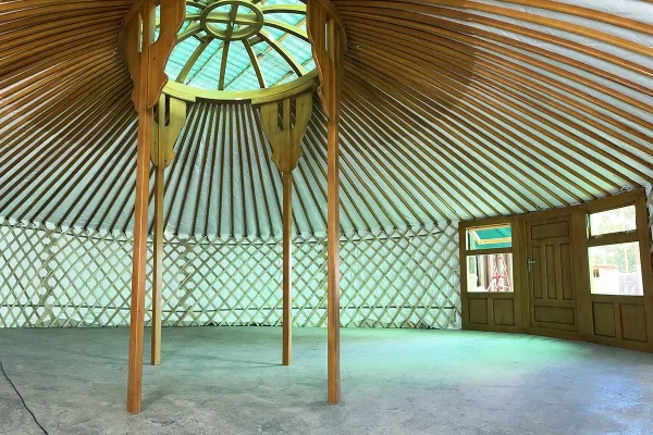 a huge Mongolian yurt with 4 pillars and teak interior